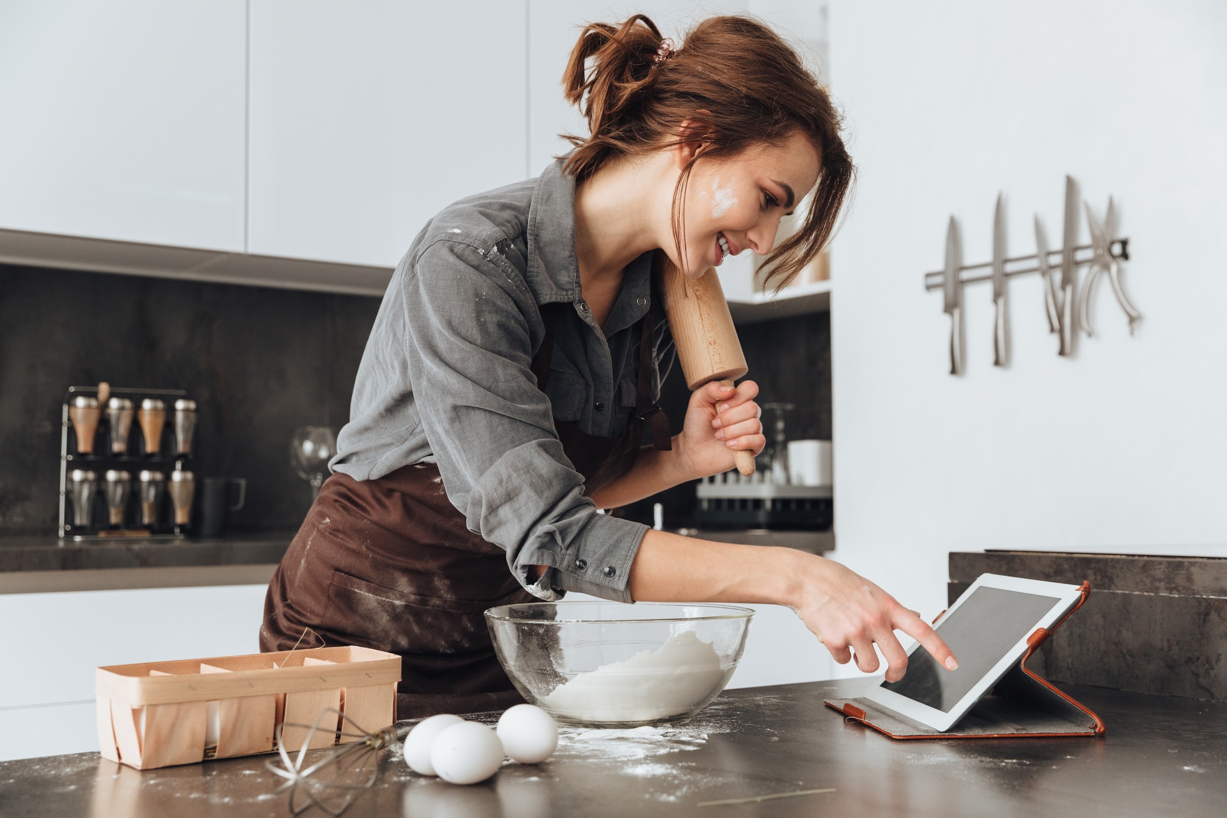 Young lady trying out a new hobby, baking in her kitchen